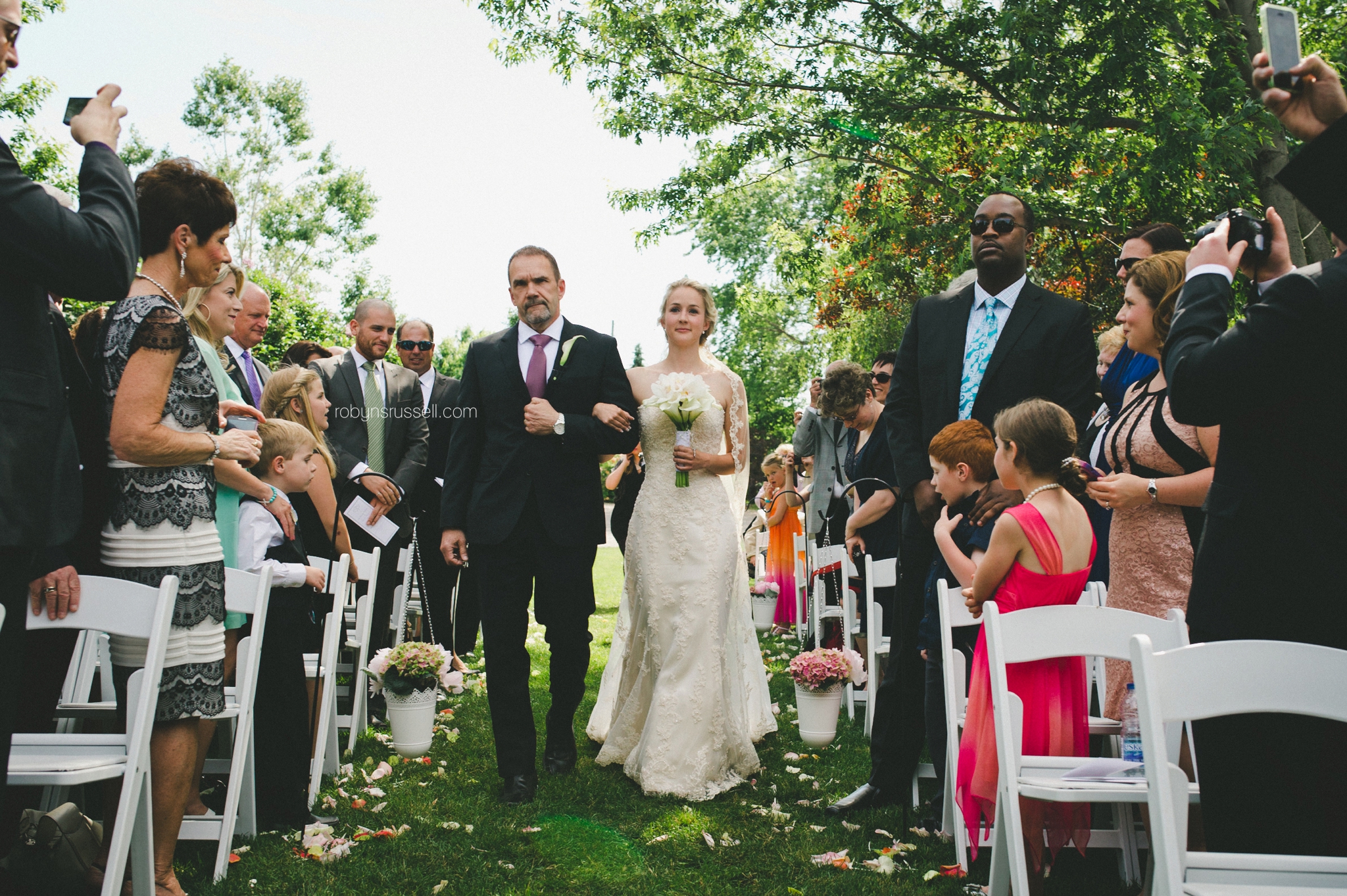 22-bride-walking-down-aisle-with-father-pipers-heath-oakville.jpg