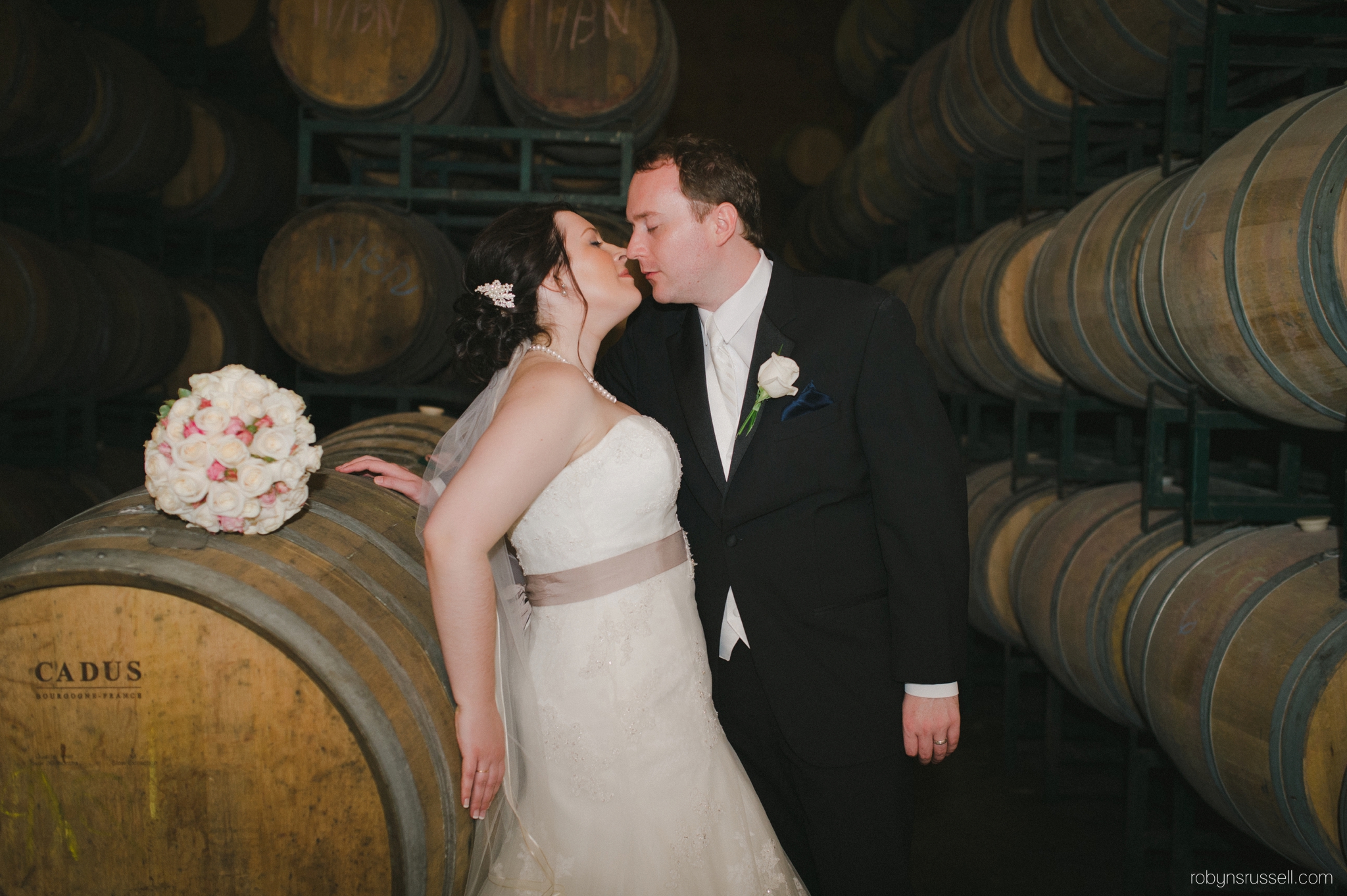 35-married-couple-in-wine-cellar-hernder-winery.jpg