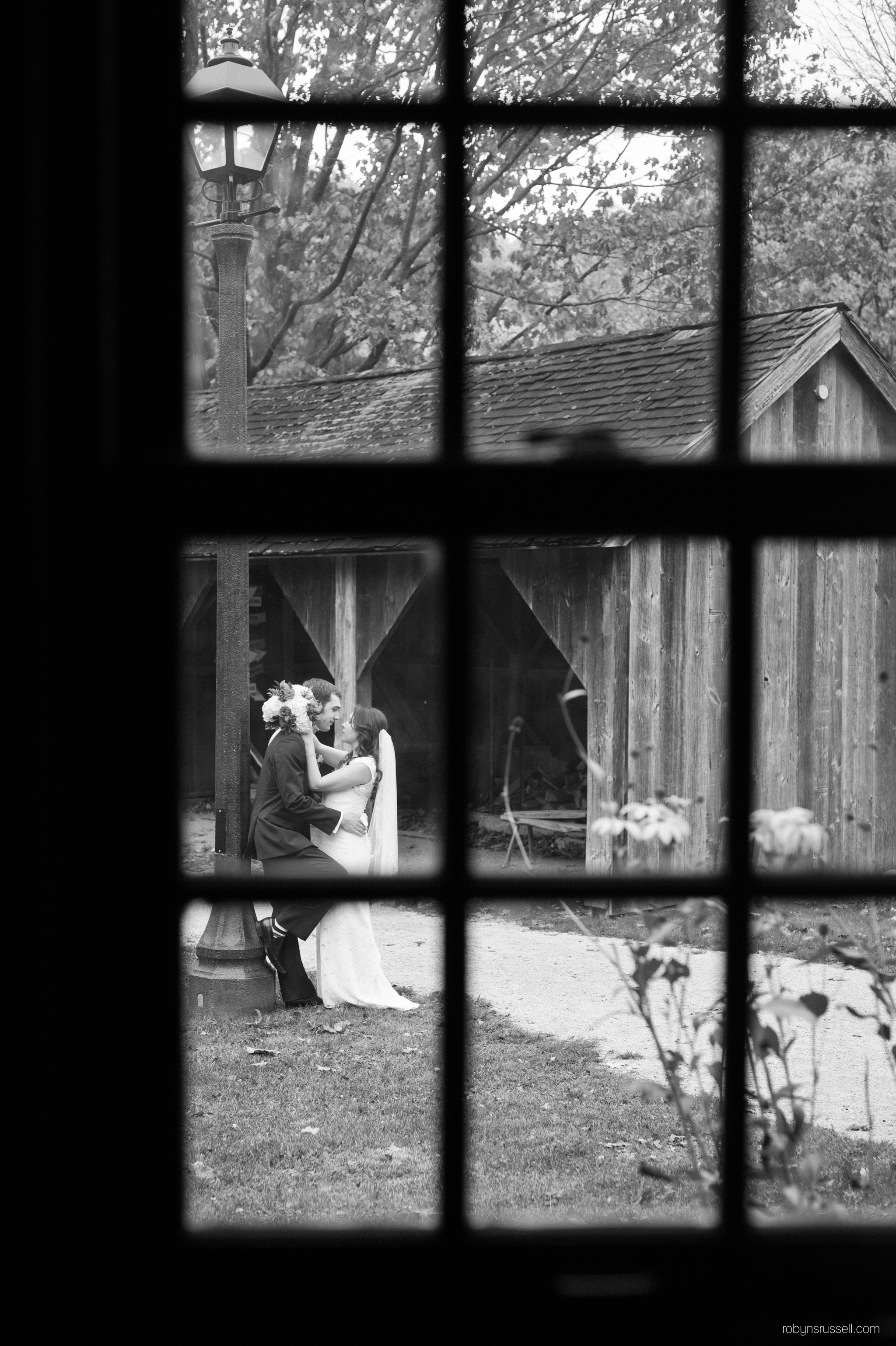 28-bride-and-groom-kissing-out-window.jpg