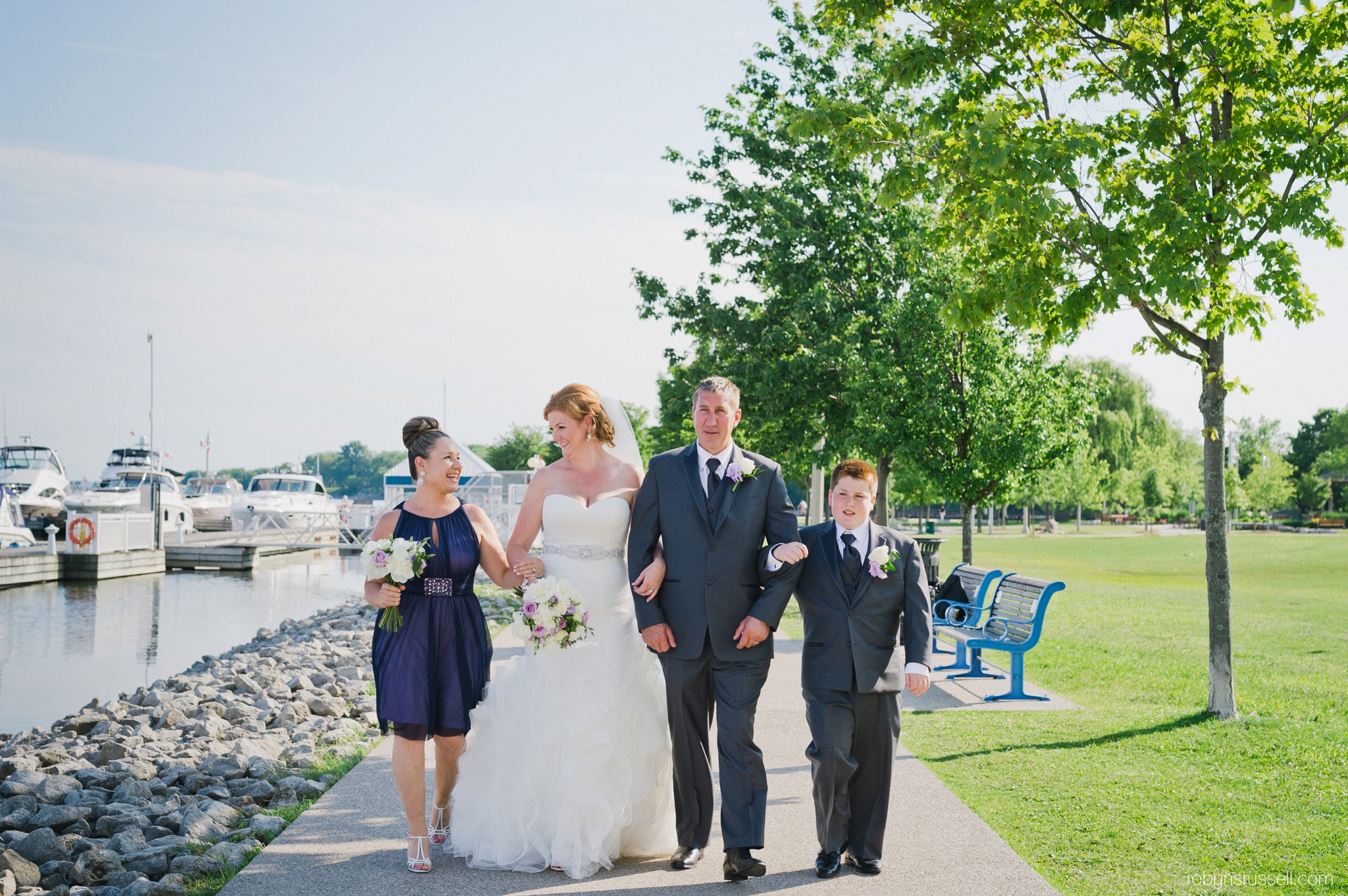 20-bridal-party-walking-along-pier-oakville-harbour.jpg