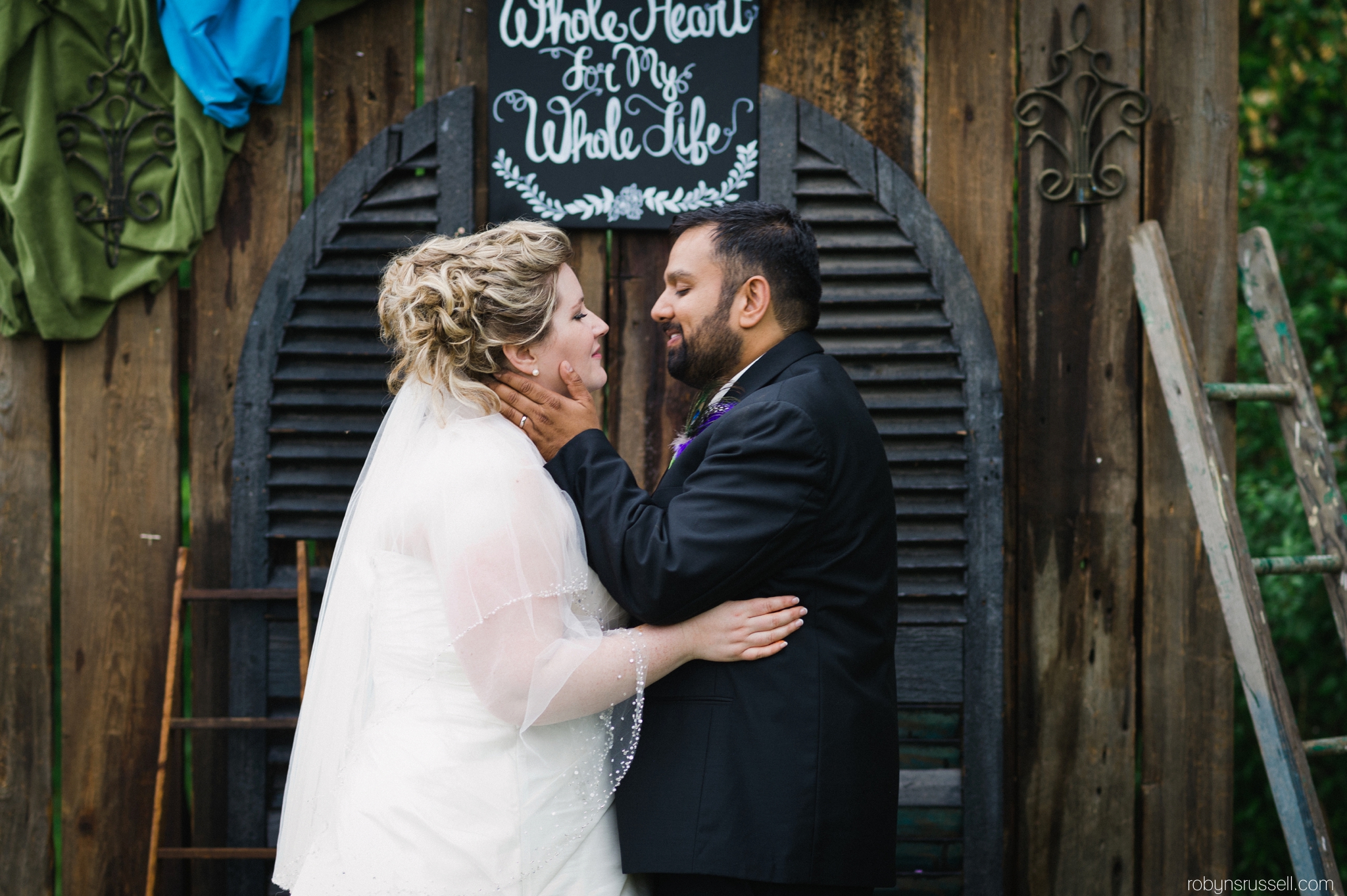 30-bride-and-groom-kissing-in-front-of-alter.jpg