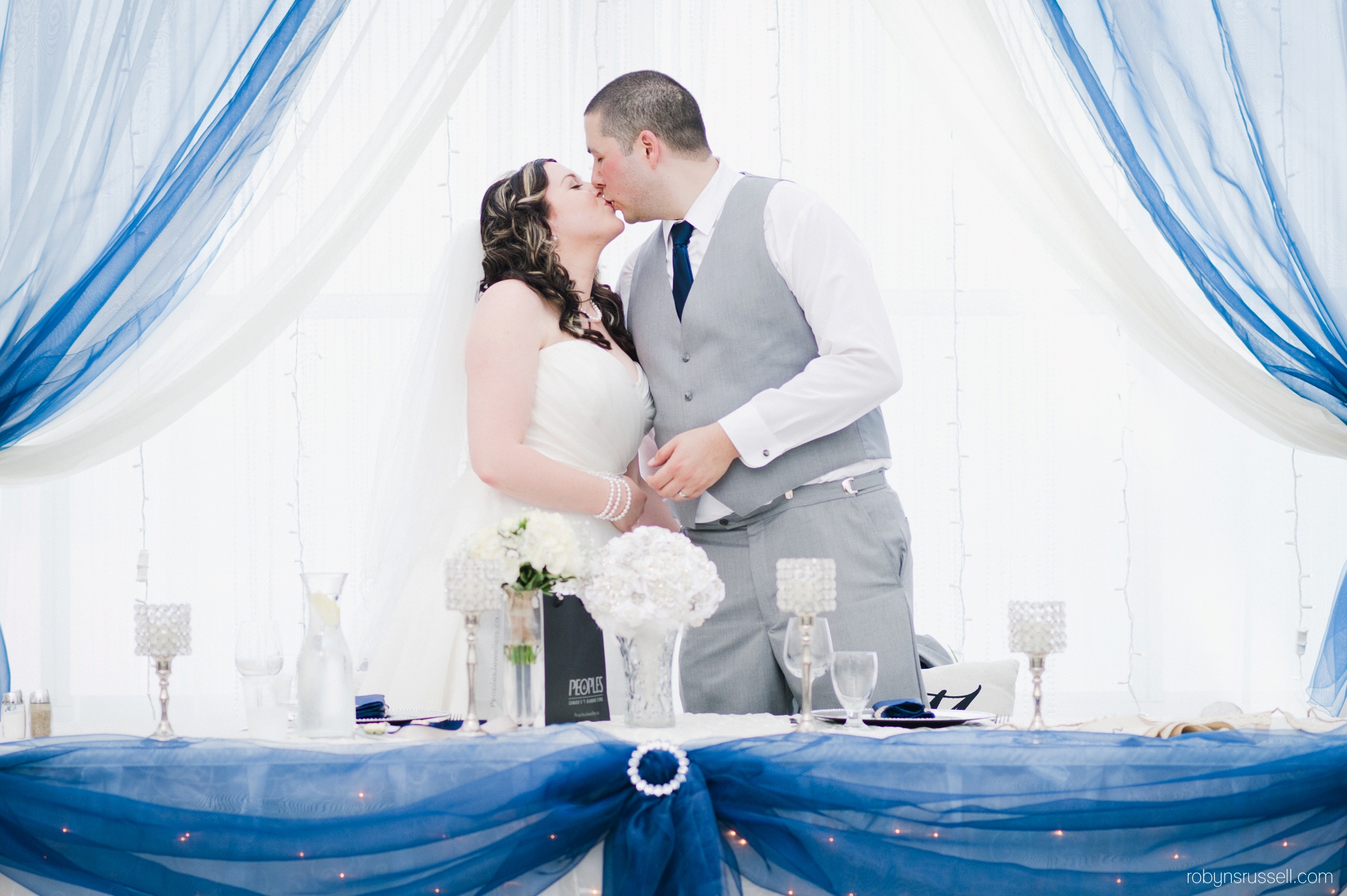 51-bride-and-groom-kiss-during-dinner.jpg